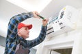 Air conditioner service. Worker at climatization system installation indoors Royalty Free Stock Photo