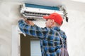 Air conditioner service. Worker at climatization system installation indoors Royalty Free Stock Photo