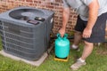 Air Conditioner maintenance with technician adding refrigerant