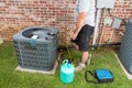 Air Conditioner maintenance with technician adding refrigerant