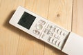 air conditioner remote control on wooden floor Royalty Free Stock Photo