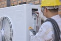 Air conditioner repairmen work on home unit Royalty Free Stock Photo