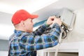 Air conditioner service. Worker at climatization system installation indoors Royalty Free Stock Photo