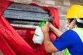 Air conditioner technician cleaning air conditioner indoors