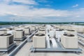 Air conditioner units HVAC on a roof of industrial building with blue sky and clouds in the background. Neural network Royalty Free Stock Photo