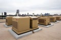 Air conditioner units HVAC on a roof of industrial building with blue sky and clouds in the background. Neural network Royalty Free Stock Photo