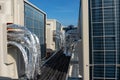 Air conditioner units HVAC on a roof of new industrial building with blue sky and clouds in the background Royalty Free Stock Photo