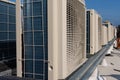 Air conditioner units HVAC on a roof of new industrial building with blue sky and clouds in the background Royalty Free Stock Photo