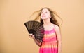 Air conditioner. Waving to create current air. Little girl waving elegant fan. Summer heat. Fresh air. Kid girl fanning