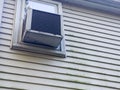 Air conditioner window unit with moldy on vinyl siding Royalty Free Stock Photo