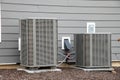 air conditioners installed on the street near the wall of the house