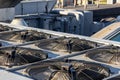 Air conditioners on the roof of an industrial building, large fans on the roof of a house