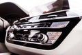 Air conditioning button inside a car. Climate control AC unit in the new car. Modern car white leather interior details. Car detai Royalty Free Stock Photo