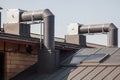 Air conditioning equipment atop a new metal roof of modern building.