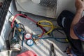 Air conditioning, HVAC service technician using gauges to check refrigerant Royalty Free Stock Photo