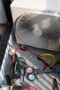 Air conditioning, HVAC service technician using gauges to check refrigerant