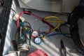 Air conditioning, HVAC service technician using gauges to check refrigerant