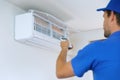 Air conditioning - worker install conditioner in the room Royalty Free Stock Photo