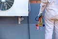 Air conditioning repairman carrying tools, gauges for measuring liquid and pressure Royalty Free Stock Photo