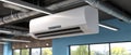Air conditioning systems are mounted on the ceiling of a large industrial facility, enhancing airflow and climate control Royalty Free Stock Photo