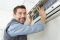 Air conditioning technician preparing to install new air conditioner Royalty Free Stock Photo