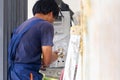 Air conditioning technicians install new air conditioners in homes, Repairman fix air conditioning systems, Air conditioning unit Royalty Free Stock Photo