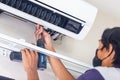 Air conditioning technicians install new air conditioners in homes, Repairman fix air conditioning systems, Male technician Royalty Free Stock Photo