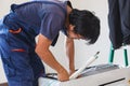 Air conditioning technicians team install new air conditioners in homes, Repairman fix air conditioning systems, Male technician