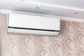 Air conditioning on the wall inside the room in apartment, switched off. Interior in calm beige tones. Close-up