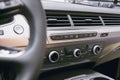 Air ducts and climate control panel in a luxury car with leather top panel. Deflectors Royalty Free Stock Photo