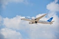 Air Europe plane taking off into blue cloudy sky