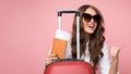 Air flight journey. Woman with suitcase showing thumb up