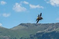 Air force F-35 from a demonstration team performs aerobatics at Hill AFB against Wasatch Mountains