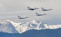 Air Force Thunderbirds Fly over Snow Capped Rocky Royalty Free Stock Photo