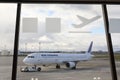 Air France passenger plane parked at Toulouse Blagnac airport through navigation symbols in terminal