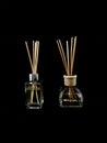 Air freshener on a black background. Incense sticks in a container with perfume. Aromatherapy canes in a glass bottle with oil Royalty Free Stock Photo