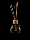 Air freshener on a black background. Incense sticks in a container with perfume. Aromatherapy canes in a glass bottle with oil Royalty Free Stock Photo