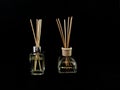 Air freshener on a black background. Incense sticks in a container with perfume. Aromatherapy canes in a glass bottle with oil Royalty Free Stock Photo