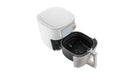 An air fryer with the basket fully removed and placed in front. Royalty Free Stock Photo