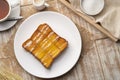 Air fryer grilled butter toast,golden brown crispy bread topped with sugar and sweetened condensed milk on white plate
