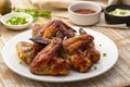 Air Fryer grilled chicken wings on white plate,served with ketchup and mayonnaise