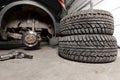 Air gun to tighten a tire bolts on a suspended car at an auto shop Royalty Free Stock Photo