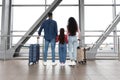 Air Journey. Family In Airport Holding Hands And Looking At Window Royalty Free Stock Photo