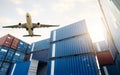 Air logistics. Cargo airplane flying above stack of logistic container. Cargo and shipping business. Container ship for export Royalty Free Stock Photo