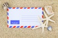 Air mail envelope on the sand decorated with sea shells and Star Royalty Free Stock Photo