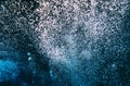 Air oxygen bubbles floating swimming up and boiling dark blue deep water forming different shapes some in focus blur coming up on Royalty Free Stock Photo