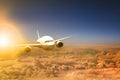 Air plane flying over cloud scape and sun light behind