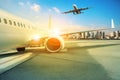 Air plane parking in airport and flying over building in city