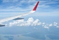 Air plane wing against blue sky and scattered clouds background. Royalty Free Stock Photo