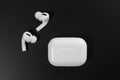 Air Pods Pro. with Wireless Charging Case. New Airpods pro on black background. Airpods Pro. Copy space Royalty Free Stock Photo